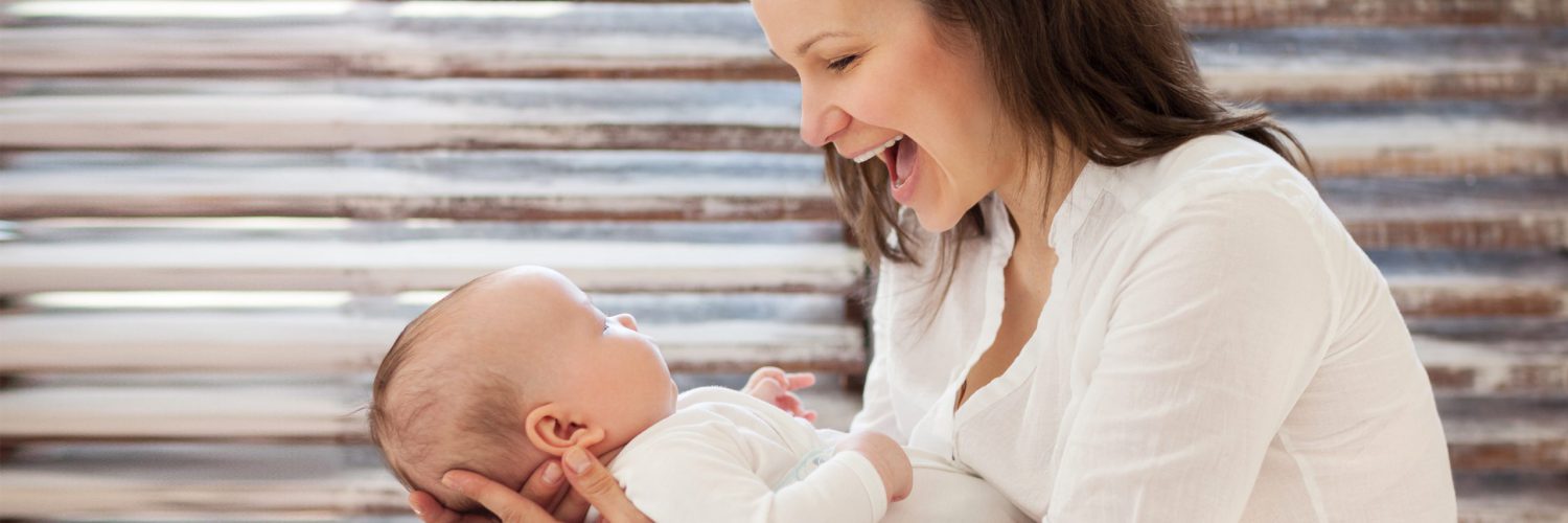 Portrait of a happy mother and child laughing and playing