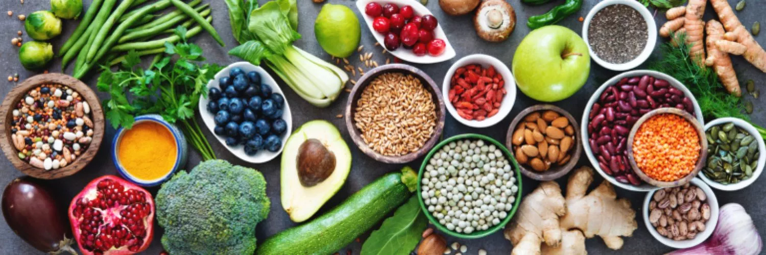 Healthy food selection with fruits, vegetables, seeds, superfood, cereals on gray background